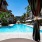a pool with umbrellas and chairs next to it