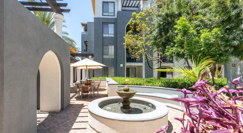a fountain and landscaping near a building