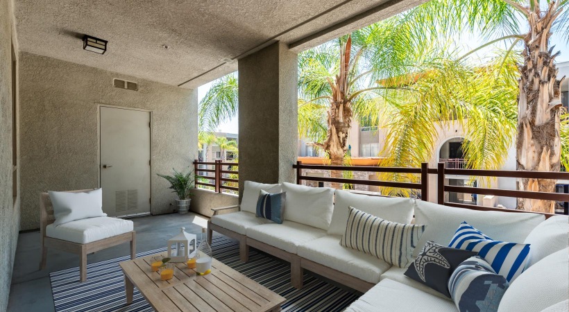 Generous balconies balcony with couch and coffee table