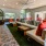 a lounge room with a couch and a fan