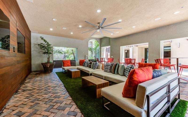 a lounge room with a couch and a fan