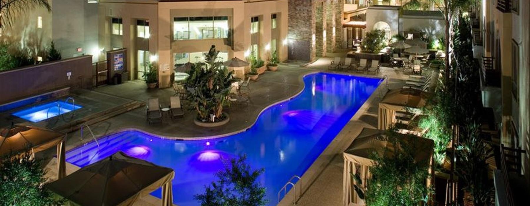 aerial view of a swimming pool at night in a courtyard